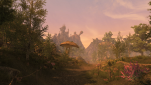 A wide screenshot of the lush Ascadian Isles region in golden sunlight, with steep mountains in the distance
