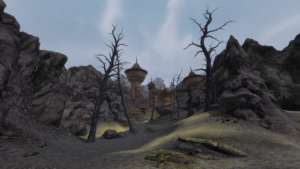 An in-game screenshot of a sulfur-choked valley in a craggy landscape, leading to a half-buried Dwemer ruin